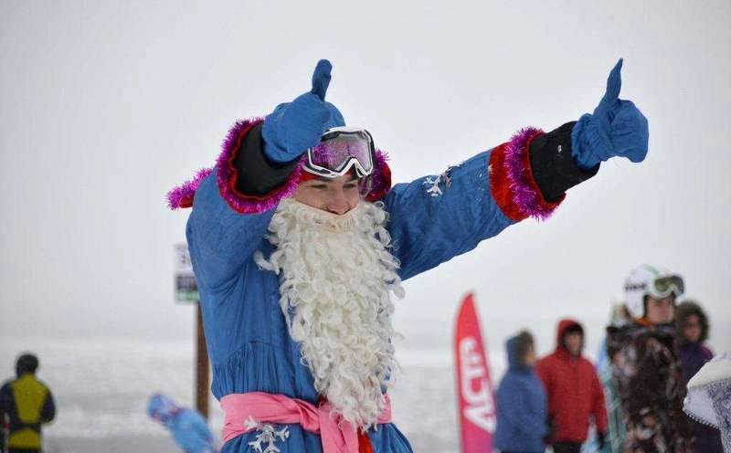 Десятки сахалинских лыжников и сноубордистов в костюмах дедов морозов и снегурочек спустились с вершины горы Большевик